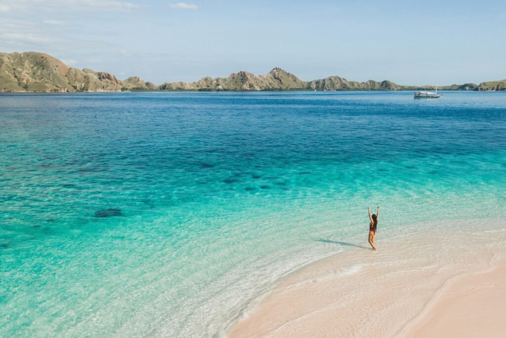 Tropical vacations concept. Happy woman enjoying on beach with a